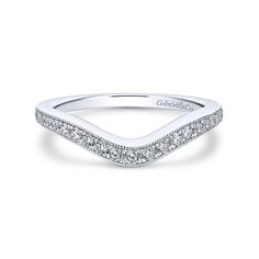 a white gold curved wedding band with pave set diamonds on the edges and sides