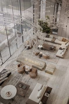 an aerial view of a living room with couches, tables and chairs in it