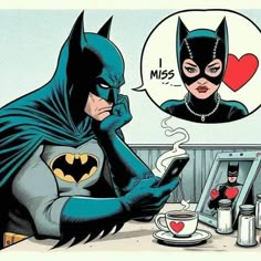 the batman is talking on his cell phone while drinking coffee and looking at her reflection in the mirror