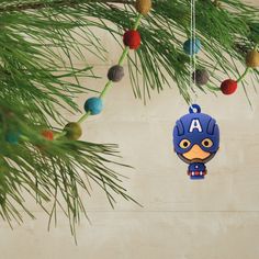 a christmas ornament hanging from a pine tree with ornaments on the branches around it