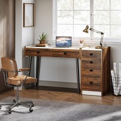 a desk with a laptop on it and a chair next to it in front of a window