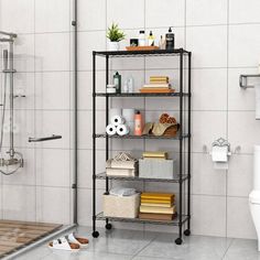 a bathroom with a toilet, shower and shelving unit next to it is shown