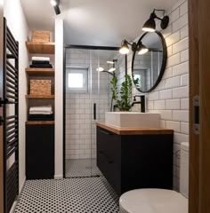 a bathroom with black and white tile flooring