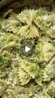 a bowl filled with pasta and broccoli covered in parmesan sprinkles