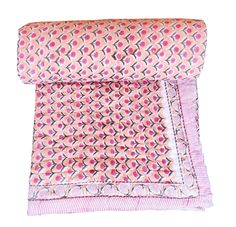 a pink and blue patterned pillow on a white background