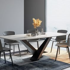 a dining table with chairs around it and a vase on the table next to it