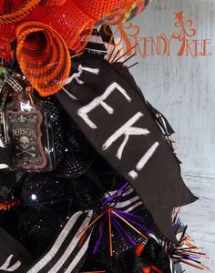 a halloween tree with black and orange decorations