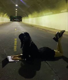 a person laying on the ground using a laptop