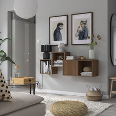 a living room filled with furniture and pictures on the wall