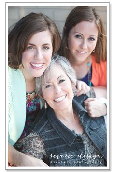 two women are smiling for the camera while one woman has her arm around another woman's shoulder