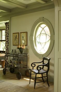 a living room filled with furniture and a round window