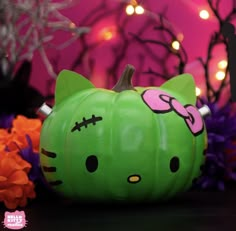 a green hello kitty pumpkin sitting on top of a table