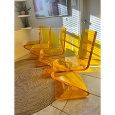 three yellow chairs sitting on top of a rug