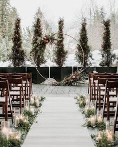 an outdoor ceremony setup with candles and greenery