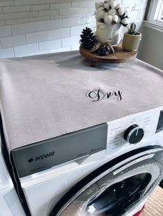 a dryer sitting on top of a washing machine