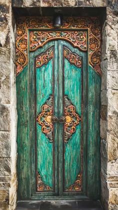 an old wooden door with ornate carvings on the side of a stone building in europe