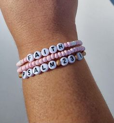 Religious Seed Bead Bracelet, Praise Bracelet, Pray Bracelet, Faith Bracelet, Bible Verse Jewelry, Psalm 46:5 Bracelet, Psalm 23:1 Bracelet, Christian Gift, Faith Jewelry, Neutral and Pink Seed Bead Bracelet, Scripture How to find your bracelet size: Wrap a flexible tape measure, string, or ribbon around your wrist. Find your measurement and then add 1/2 an inch. This will ensure a comfortable fit for your stackable bracelets.   Bracelet care: -remove when sleeping -avoid over stretching -allow lotions to dry before wearing -remove before entering water -Made with clear stretchy elastic cord. Looking for different text on your bracelet?  Feel free to contact me with any personalization. Bracelet Ideas Christian, Pray Bracelet, Cute Clay Bead Bracelet Ideas, Pink Seed Bead Bracelet, Verse Bracelet, Prayer Jewelry, Clay Bead Bracelet Ideas, Bible Verse Jewelry, Bible Verse Bracelet