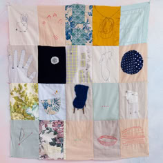 a patchwork wall hanging with various hand and foot prints on it's sides