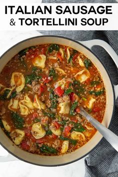 a large pot filled with tortellini soup on top of a table