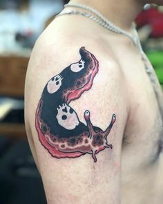 a man with a tattoo on his arm that has an image of two dogs in the shape of a heart