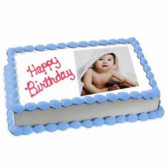 a blue and white birthday cake with a photo on it