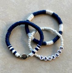 three bracelets with words written on them sitting on a table next to each other