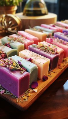 soaps with flowers and herbs on a wooden tray