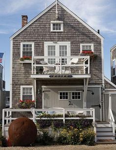 a house with an ocean view is shown in the daytime hours and has white shutters on the windows