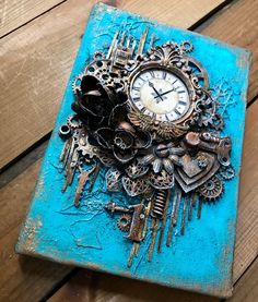 an altered clock is sitting on top of a blue box that has gears and keys attached to it