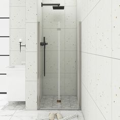 a white tiled bathroom with a walk in shower