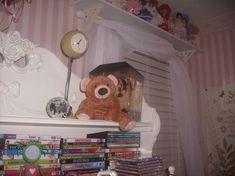 a teddy bear sitting on top of a shelf