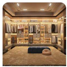 a large walk in closet with lots of clothes on the walls and shelves, along with a blue ottoman