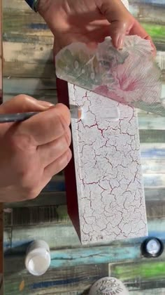 someone is painting on a piece of paper