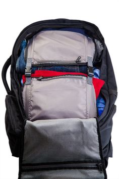 an open backpack filled with clothes and other items