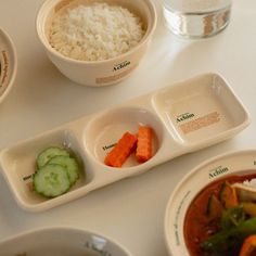 there are three bowls with different foods in them on the table next to each other