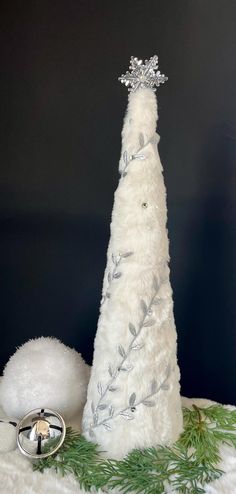 a white christmas tree sitting on top of a table