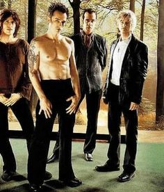 the cast of lost boys standing in front of a window with their shirtless bodies