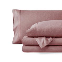 the pink sheets and pillow cases are neatly folded