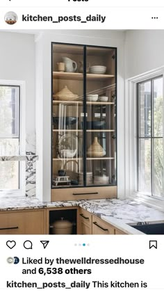 a kitchen with marble counter tops and wooden cabinets, along with glass doors that lead to the outside