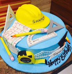 a birthday cake that is shaped like a tennis racket, helmet and other items