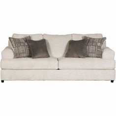 a white couch with two pillows on it