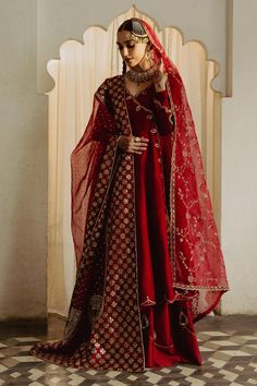 a woman in a red and gold wedding outfit