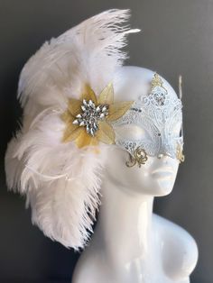 Our women's white laser cut metal masquerade mask, adorned with delicate white feathers and a gold crystal brooch, offers you the opportunity to add a touch of enchanting gold glitter to the mask. Whether you're attending a grand masquerade ball, a themed gala, or simply looking to add a touch of elegance to your attire, this mask ensures you'll be the center of attention.


Age Group/Gender - Adult/Women

Size/Type - One size fits all adults

Mask Color - White

Mask Material - Laser cut metal Elegant Headpieces For Masquerade Carnival, Elegant Headpieces For Carnival Masquerade, Elegant White Masquerade Mask For Weddings, Elegant White Wedding Masquerade Mask, Elegant Feathered Eye Mask For Masquerade, Elegant White Masquerade Mask For Carnival, White Venetian Masquerade Mask For Wedding, Elegant White Masquerade Mask For Mardi Gras, White Masks For Carnival Party