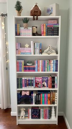 a white book shelf filled with lots of books