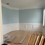 an empty room with hard wood flooring and blue paint on the walls in it