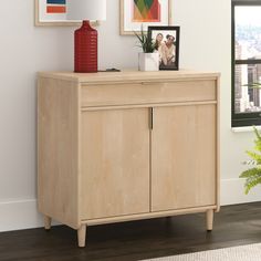 For a convenient storage space addition to any spot in your home, look no further than the 2-door base cabinet from the Clifford Place® collection. This base storage cabinet features a spacious drawer that opens and closes on full extension slides. This easy access drawer makes the perfect spot to store miscellaneous papers, your collection of notepads, phone chargers, your planner, and more. Behind the double doors of this library storage cabinet is a hidden area that includes a large adjustable shelf to accommodate all your additional stow-away needs. Use the adjustable shelf to customize your library cabinet to your specific demands. A grommet hole and pass-through for cord management keeps clutter at bay. Finished on all sides in a Natural Maple and accented with solid wood feet, this Library Storage, Library Cabinet, Office Bookcase, Phone Chargers, Cord Management, Base Cabinet, Cabinet Features, Executive Desk, Adjustable Shelf