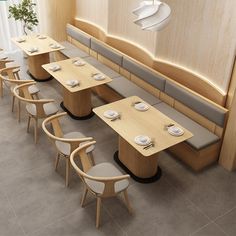 an overhead view of a restaurant with wooden tables and chairs, white plates on the table