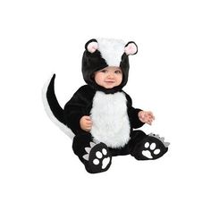 a baby in a costume sitting on the ground wearing a skunky suit and hat