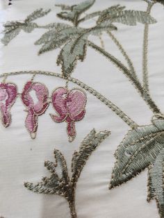 a close up view of some pink flowers on white fabric