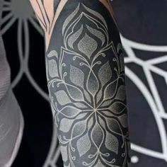 a person with a black and white tattoo on their arm